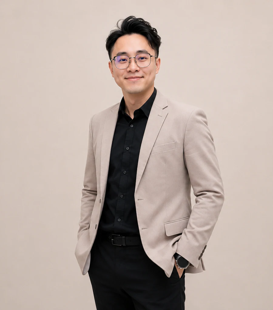 David Lau standing in a beige jacket
